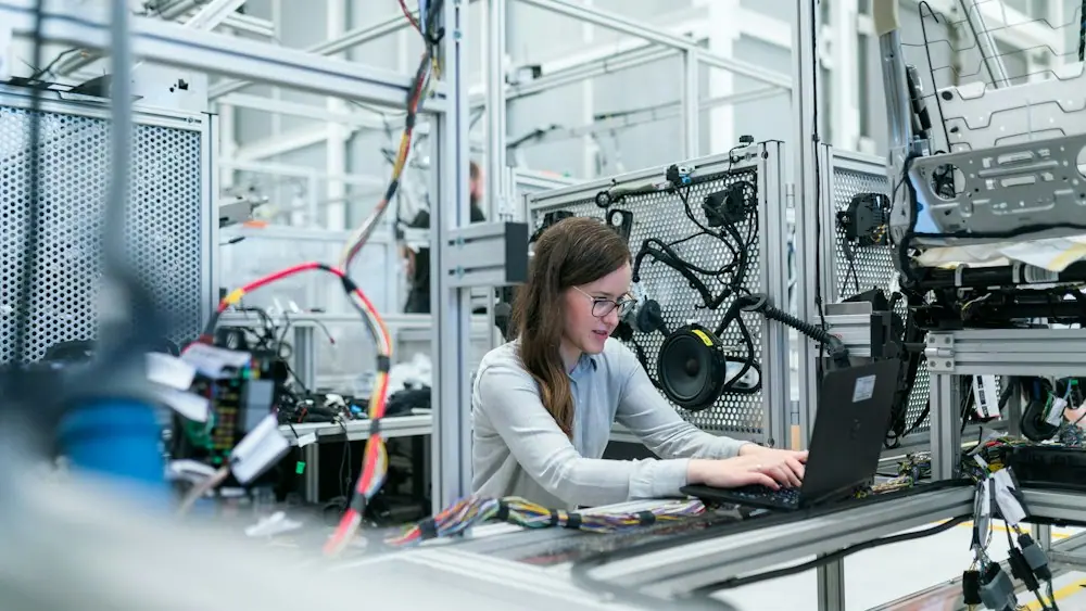 Engineer working on a laptop in a technology lab