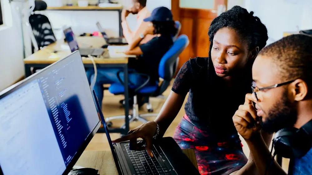 Two engineers working together at a computer