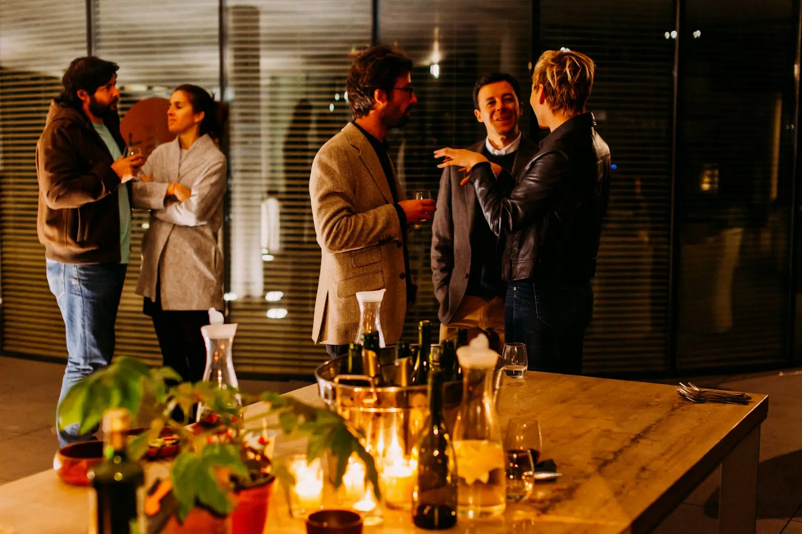 Professionals talking over drinks at an evening networking event
