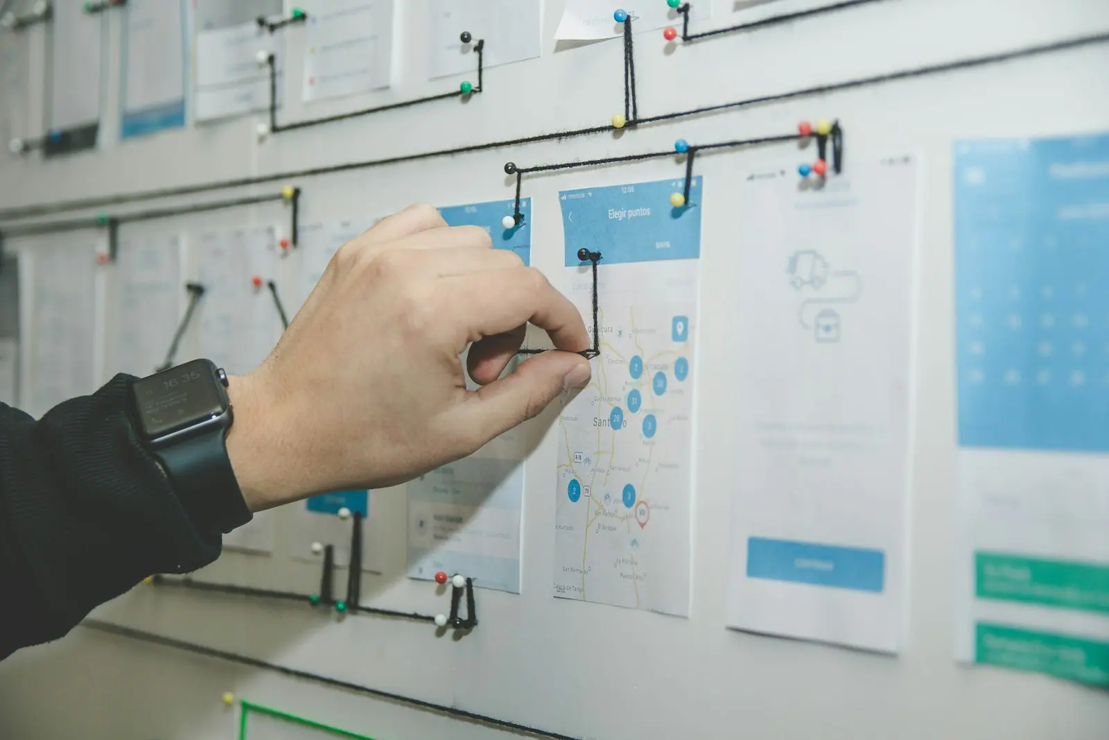 An engineer pinning cards to a project planning board