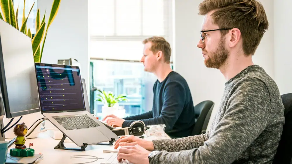 Two developers working at their workstation