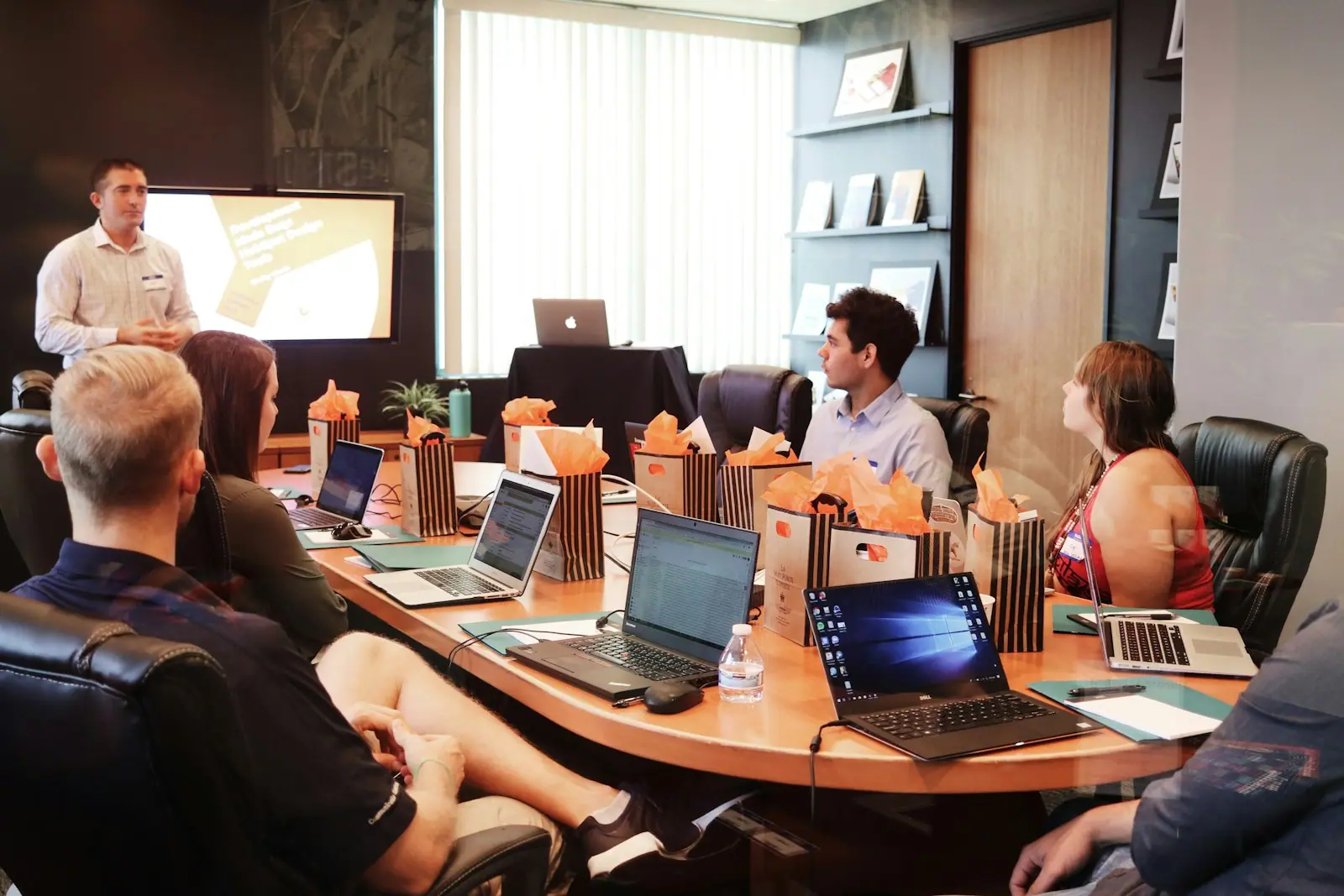 A delivery team in a review meeting around a conference table