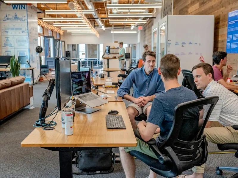 A young team discussing work together at the office
